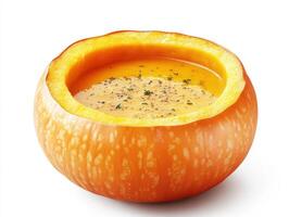 Warm pumpkin soup served in a hollow pumpkin bowl photo