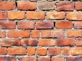 Brick wall texture showing red and brown variations in sunlight photo