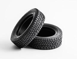 Two black tires stacked on a white background photo