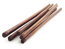 Natural wood sticks arranged on a white surface photo