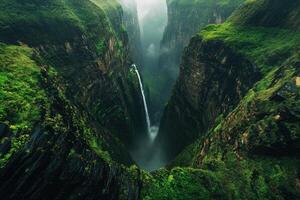 Majestic waterfall cascading through steep, green canyon walls photo