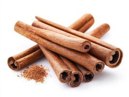 Cinnamon sticks and powder arranged on a plain background photo