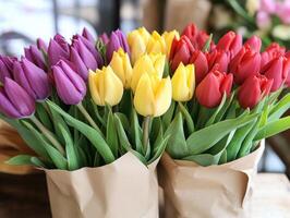 Colorful tulips arranged in brown paper wraps at a flower shop photo