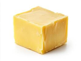 Block of creamy yellow butter on a plain white background photo