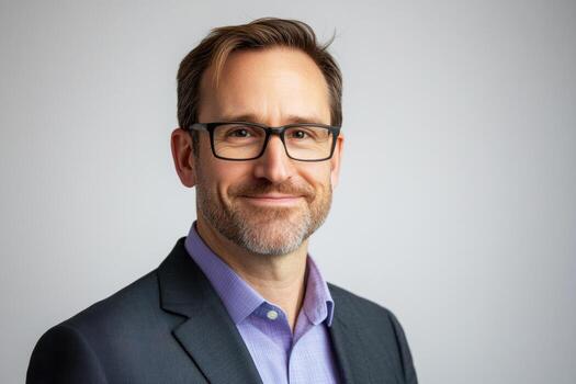 Professional man smiling in an office setting with neutral background photo
