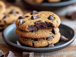 Delicious chocolate chip cookies stacked on a plate in a cozy kitchen photo