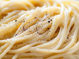 Enjoying freshly prepared spaghetti with pepper and cheese photo