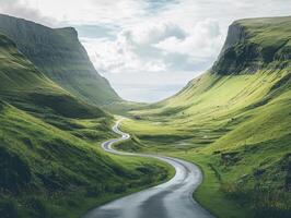 Winding road through lush green valley under cloudy sky photo