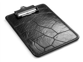 Black leather clipboard placed on a flat surface for note taking photo