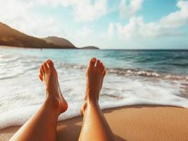 Relaxing on the beach with feet in the sand during sunset hours photo