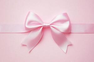 Elegant pink ribbon bow on soft pastel background photo