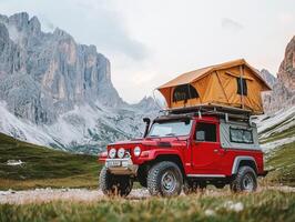 Camping adventure in the Dolomites with a red SUV and rooftop tent photo