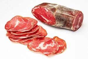 Cured meat on display with slices and whole cut photo