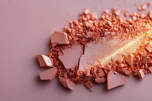 Bronzed highlighter creates a radiant glow on a clean beige background with crushed texture and soft golden light. Crushed bronzed highlighter on clean beige background, reflecting soft golden light photo