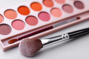 Close-up of blush palette with color-dusted brush on marble surface highlighting neutral tones. Blush palette displayed on a marble surface features a brush dusted in color for fresh makeup look photo