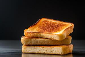 Toasted slices of bread creating a delicious stack on dark background photo