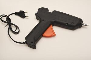 A tool for gluing. Black glue gun. photo