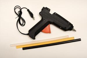 A tool for gluing.Black glue gun on a white background. photo