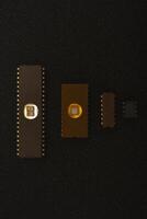 Several microchips on black foam. Old integrated circuits for radio electronics. photo
