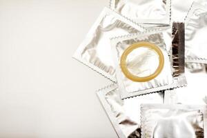 An open condom in a package. Male contraceptives. Durable Material, Trusted Strength. photo