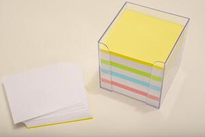 A paper block in the office. Adhesive note pad for reminders. photo