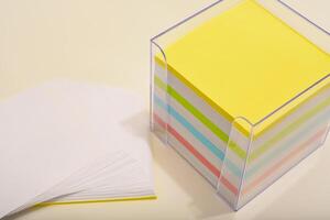A paper block in the office. Tear-off paper stack on workspace. photo