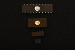 Retro-tech components for repair projects. Several microchips on black foam. Old integrated circuits for radio electronics. photo