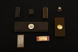 Retro integrated circuits for electronic components.Several microchips on black foam. Old integrated circuits for radio electronics. photo