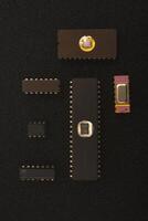 Obsolete radio electronics parts collection. Several microchips on black foam. Old integrated circuits for radio electronics. photo