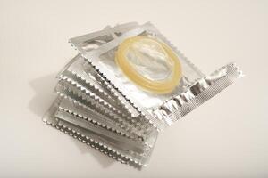 An open condom in a package. Male contraceptives.Enhanced Sensitivity, Natural Feel photo