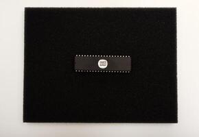 Classic chipset arrangement for electronics. The microcircuit is on black foam. An integrated circuit for radio electronics. photo