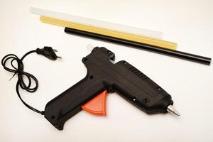 Black glue gun. A tool for gluing. photo