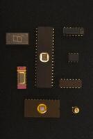 Outdated technology components display. Several microchips on black foam. Old integrated circuits for radio electronics. photo
