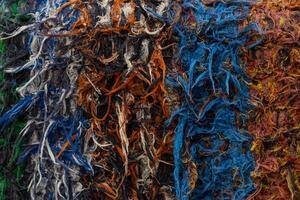 The texture of the patchwork fabric is colorful, with tangled and abstract fibers. Suitable for artistic backgrounds, textile design, and recycling concepts. photo