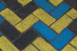 Colorful painted paving stone texture with a zig-zag pattern. Urban stone street background with contrasting colors. Perfect for graphic design, architecture, and material textures. photo