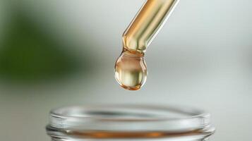 Focus on a glass dropper releasing a drop of liquid into a clear jar in a bright, natural light setting photo