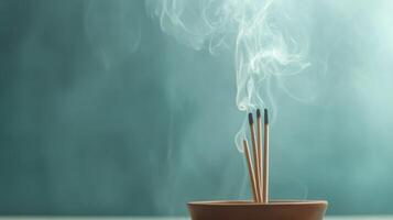 Incense sticks release aromatic smoke in a calming indoor setting at dusk photo