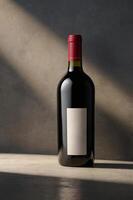 Bottle of red wine against textured backdrop with soft sunlight highlighting it in an elegant setting photo