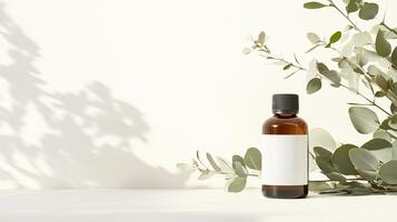 Eucalyptus essential oil bottle with blank label and green leaves on a neutral background in a bright setting photo