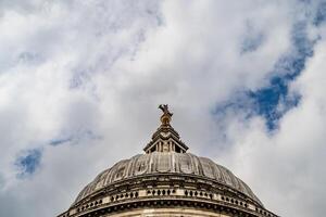 The upper dome of the Cathedral of St Paul, a ma st erpiece of English Baroque design, stands tall against the dramatic clouds. photo