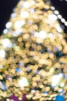 Circle Bokeh elegant Defocus on black and yellow Christmas tree is surrounded by a bokeh blur, creating a festive and abstract holiday atmosphere.1 photo