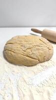 Fresh Dough on Floured Surface with Rolling Pin in a Kitchen Setting photo