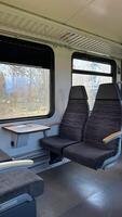 Interior of Empty Train Cabin with Large Windows and Comfortable Seats photo