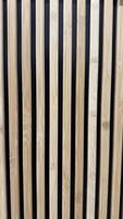 Modern Wooden Slats Against Black Background for Architectural Concept. Wooden slats arranged vertically with a black background, creating a stylish and clean design. Perfect for architectural themes, design concepts, and modern interiors. photo