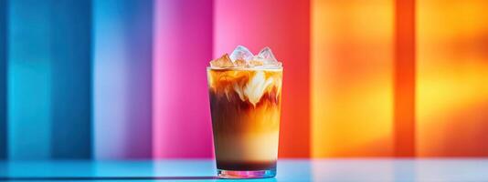 refreshing iced latte in transparent glass with layers of milk and coffee, set against vibrant, colorful background, evoking summer vibes photo