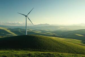 wind turbine stands tall on lush green hill, harnessing renewable energy against backdrop of rolling hills and distant mountains under serene sky photo