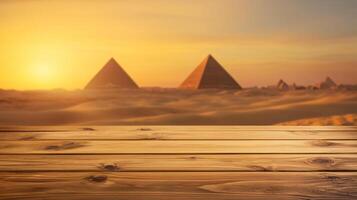 Empty wooden tabletop with blurred desert landscape featuring ancient pyramids at golden hour, evoking warmth and history photo