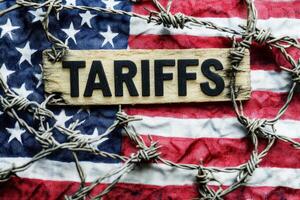 Tariffs text with United States of America Flag and barbed wire photo