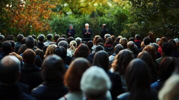 Christ event of Several people seated in chairs outdoors, attentively listening to a Christian speaker . photo