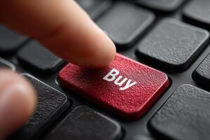 Finger presses buy button on computer photo